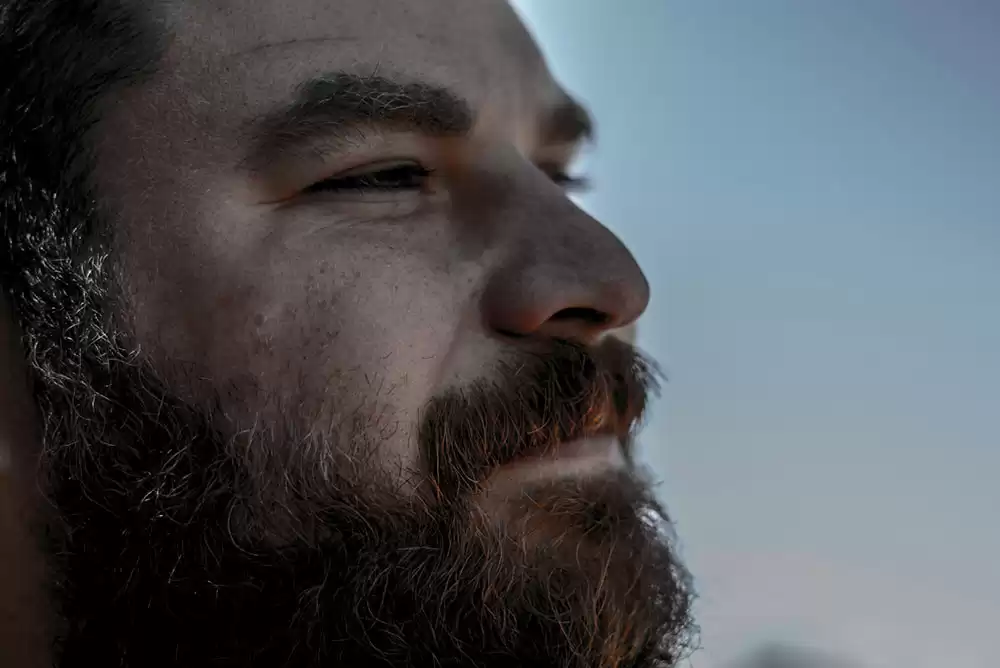 Man with a beard who just used beard oil.