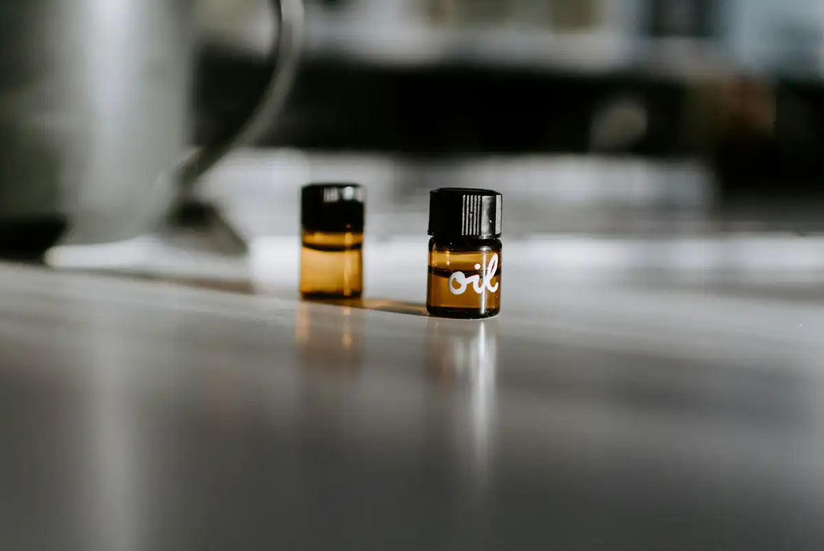 two tiny glass vials with screw threads